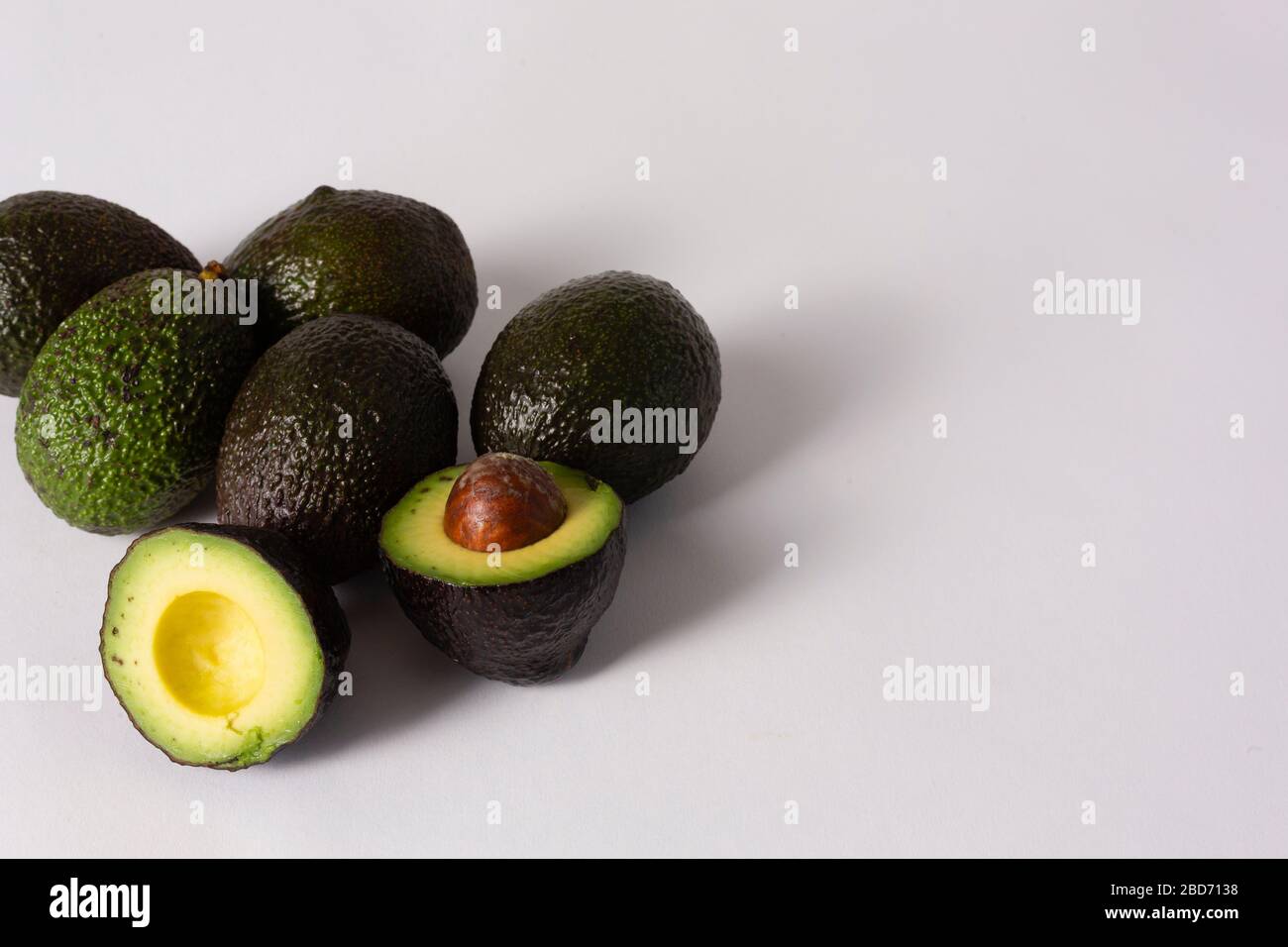 Whole and sliced avocados on white background Stock Photo - Alamy