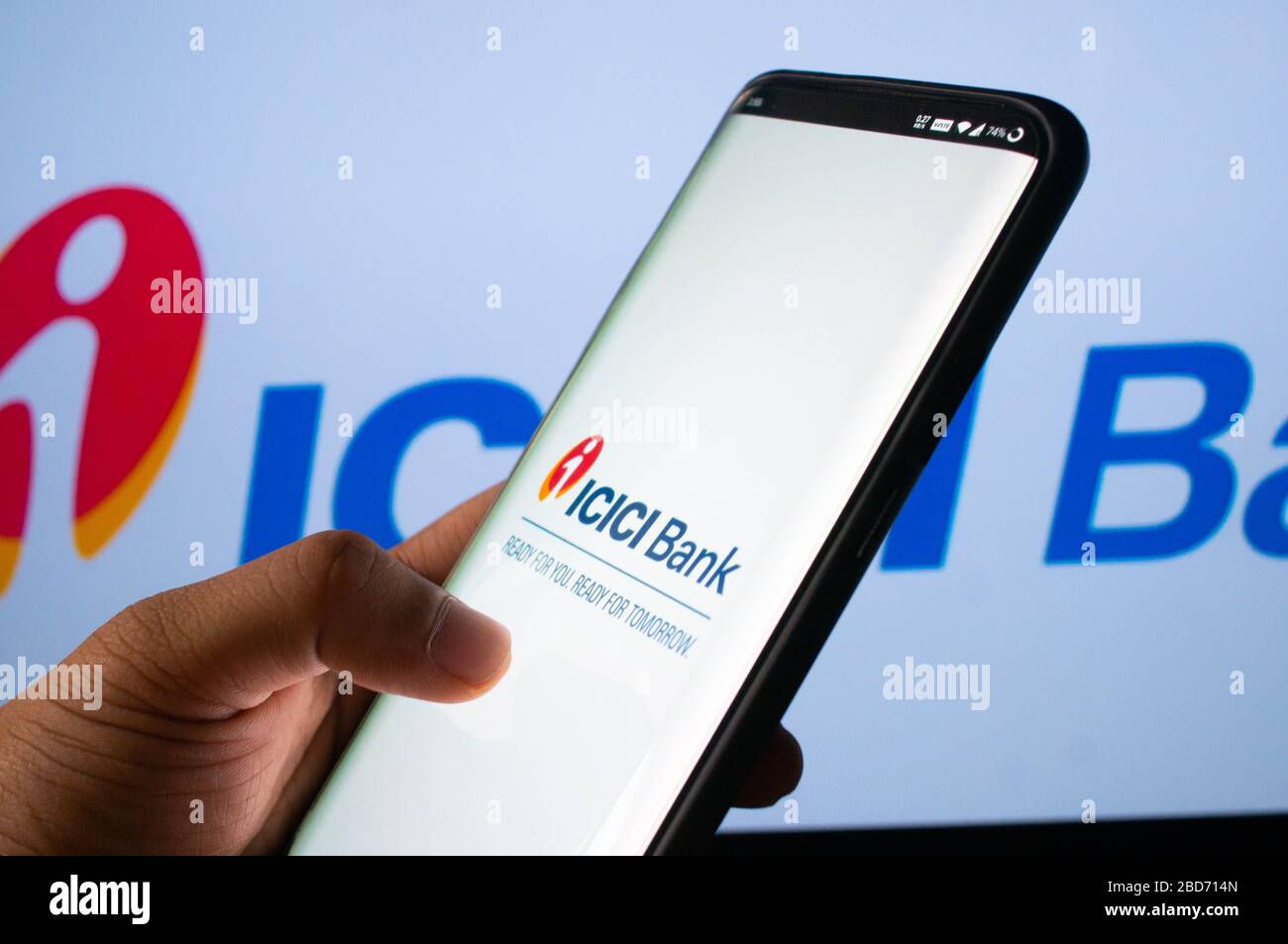 Jaipur, India, Circa 2020 - A mobile logged into the ICICI bank mobile application infront of the ICICI bank board. The background board is brightly l Stock Photo