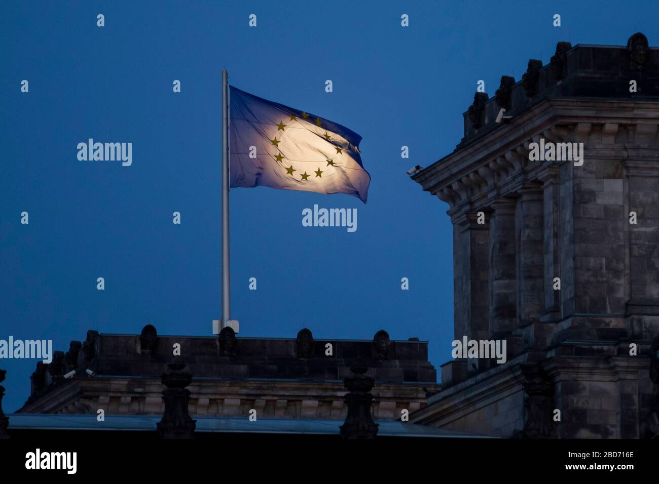 Berlin, Germany. 07th Apr, 2020. The moon rises as the so-called Supermond behind the EU flag on the Reichstag building. The moon reaches its perigee, i.e. the point closest to the Earth's orbit, on the night of 7-8 April as a full moon and therefore appears particularly large to the human observer. Credit: Christoph Soeder/dpa/Alamy Live News Stock Photo
