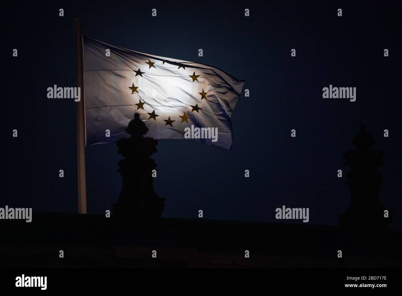 Berlin, Germany. 07th Apr, 2020. The moon rises as a so-called supermond, in the foreground an EU flag can be seen on the Reichstag building. The moon reaches its perigee, i.e. the point closest to the Earth's orbit, as a full moon in the night from 7 to 8 April and therefore appears particularly large to the human observer. Credit: Christophe Gateau/dpa/Alamy Live News Stock Photo