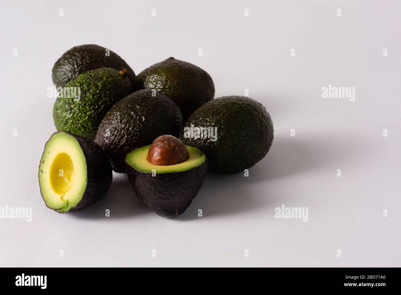 Whole and sliced avocados on white background Stock Photo - Alamy
