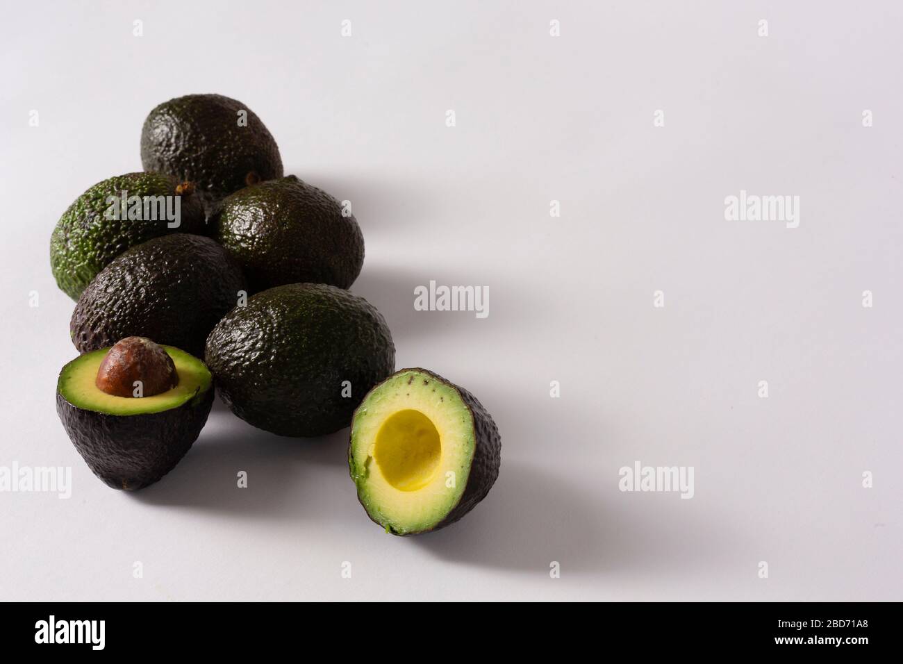 Whole and sliced avocados on white background Stock Photo - Alamy