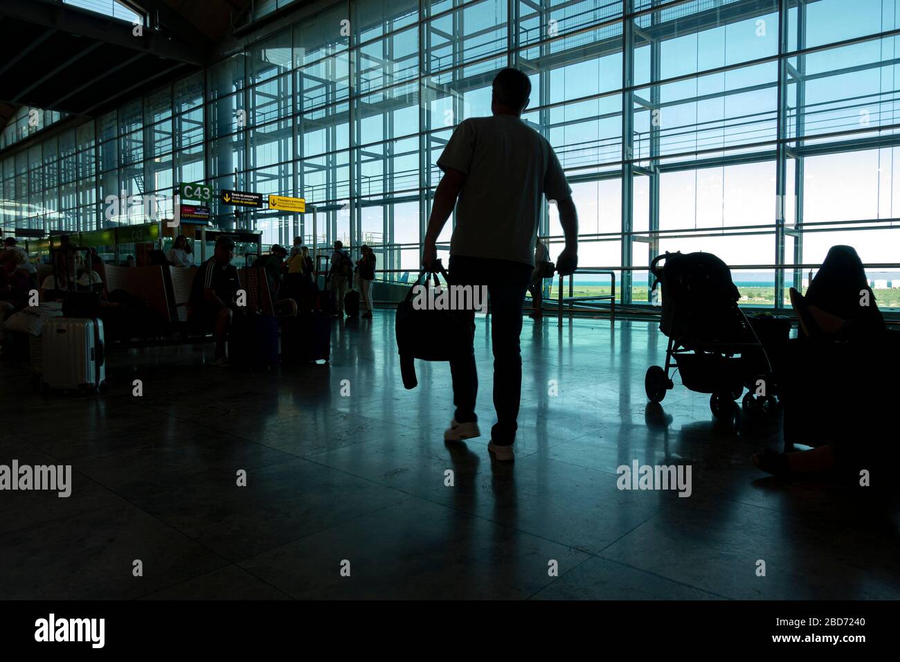 Alicante, Spain - 11 June, 2019: Silhouette of Passengers at Departure Terminal in Alicante International Airport Stock Photo