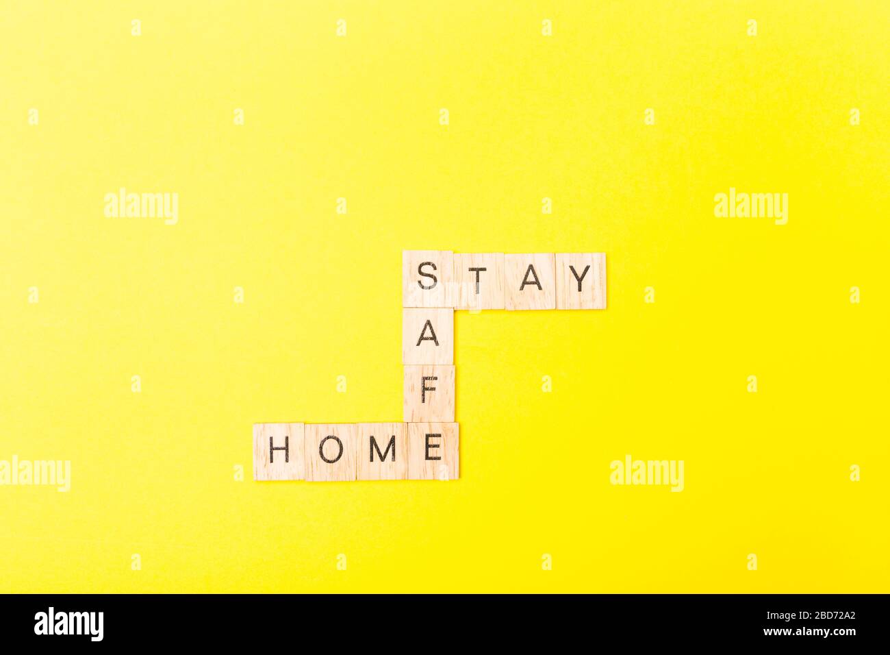 Words stay Home stay safe on wooden blocks. Concept of self quarantine at home as preventative measure against virus outbreak. Flat lay. Staying at Stock Photo