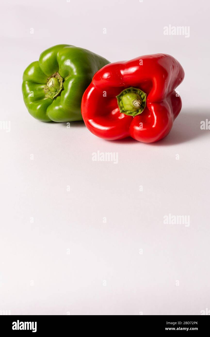 Green and red peppers on white background Stock Photo - Alamy