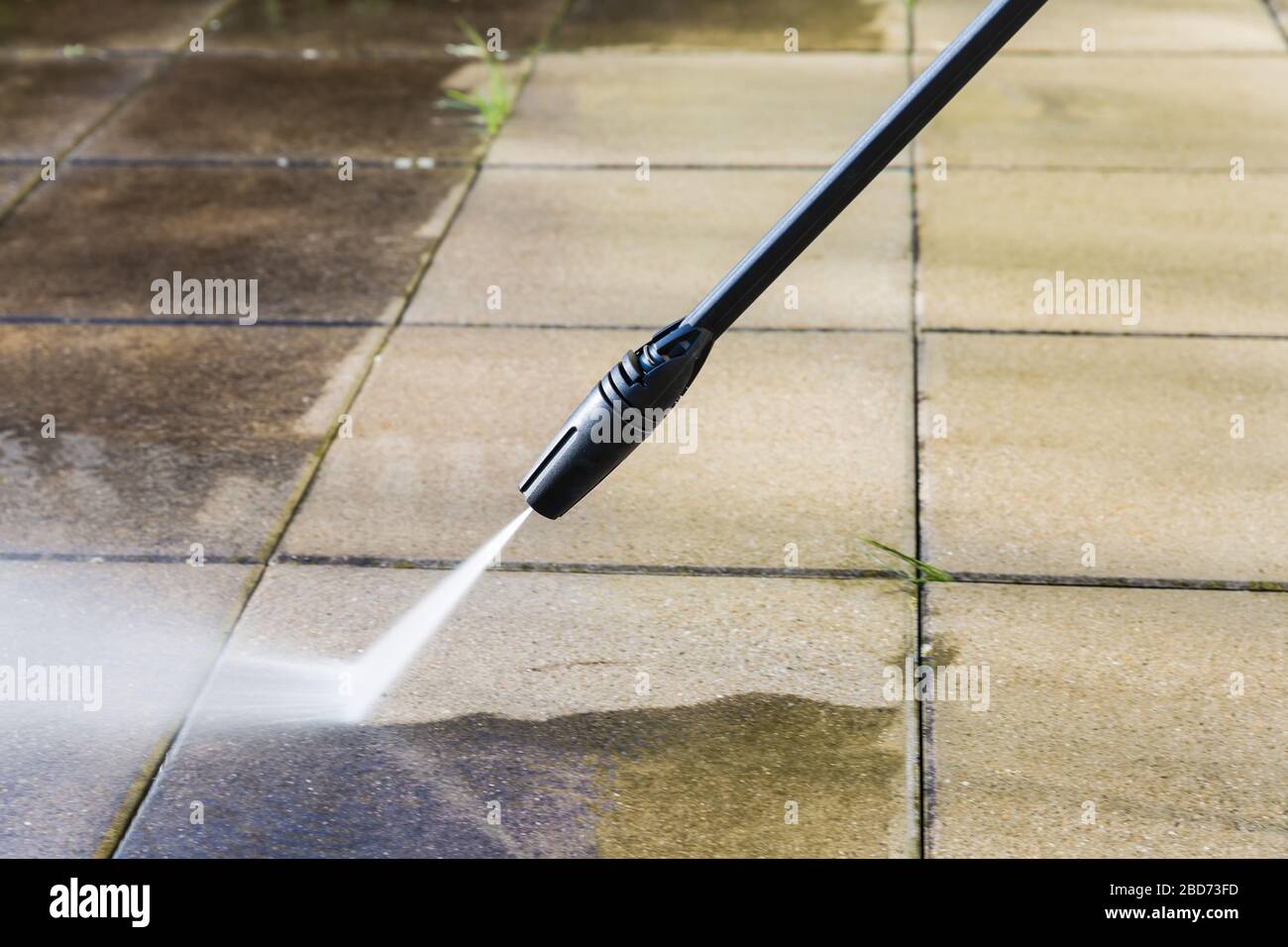 Detail of cleaning terrace with high-pressure water blaster Stock Photo