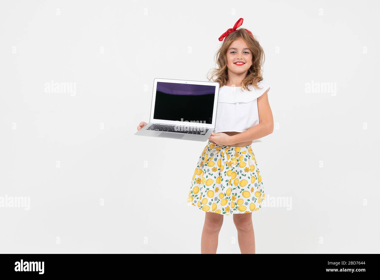stylish girl schoolgirl holds a notebook with a mockup on a white ...