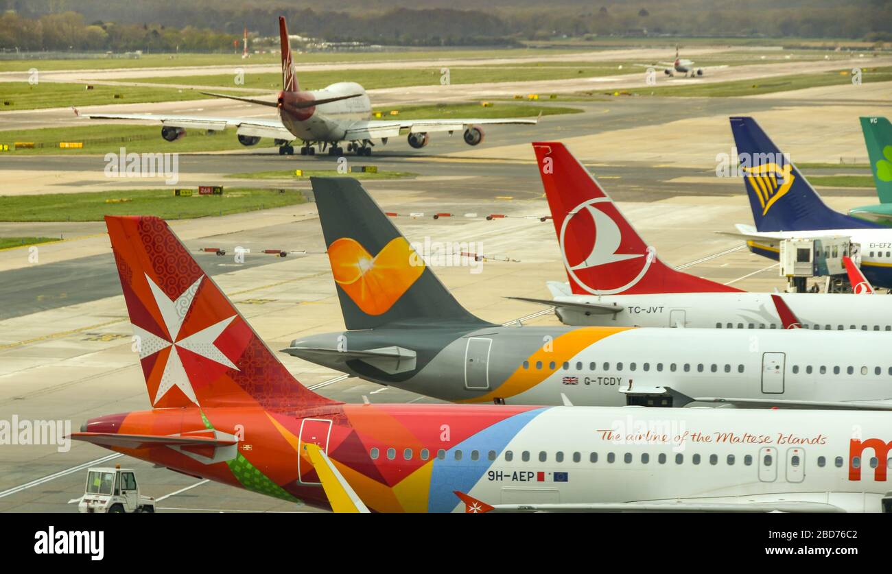 LONDON GATWICK AIRPORT - APRIL 2019: Row of jets parked at the South terminal of London Gatwick Airport Stock Photo