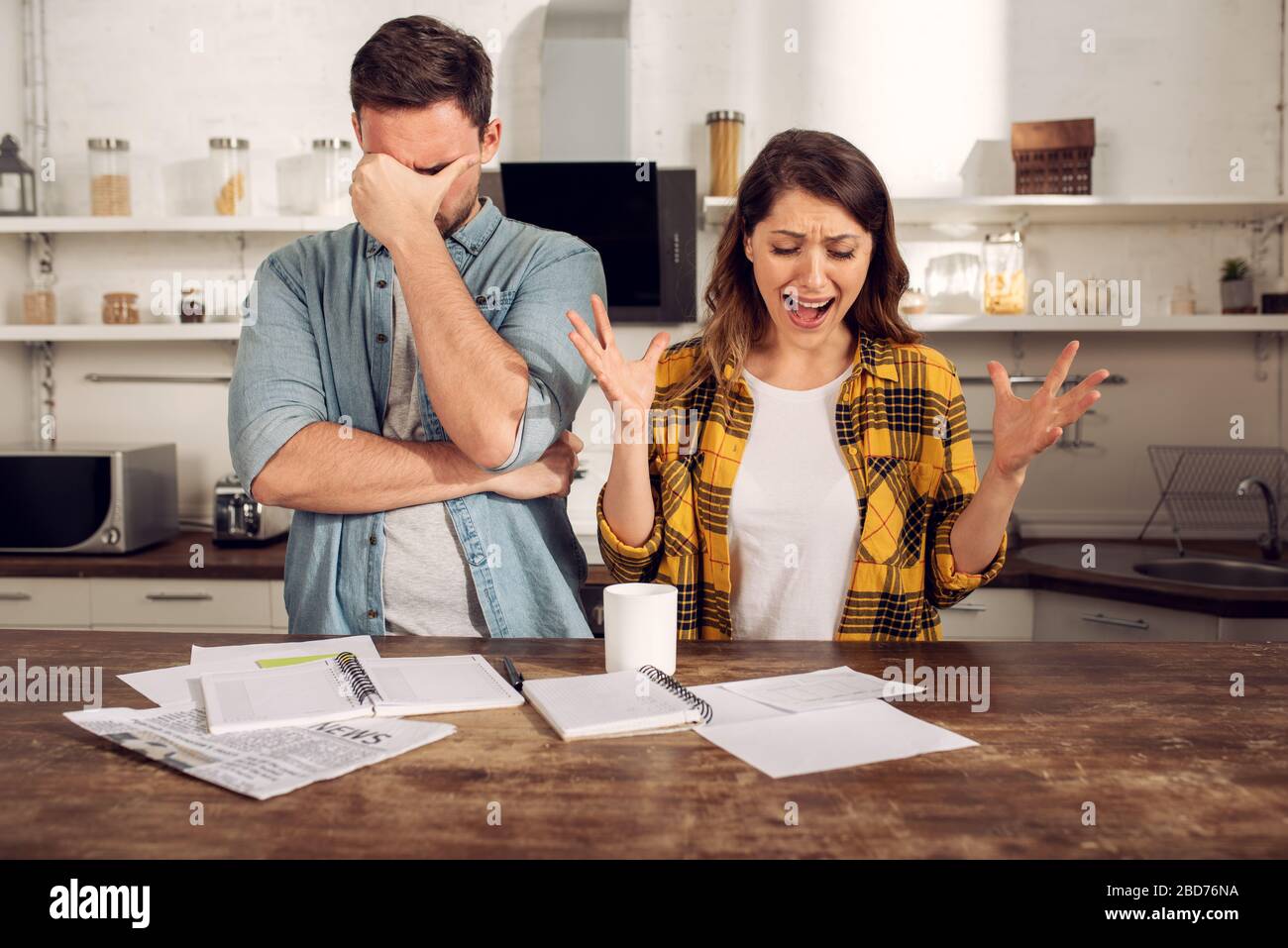 Couple have a problem with bills. Concept of economic trouble and failure Stock Photo