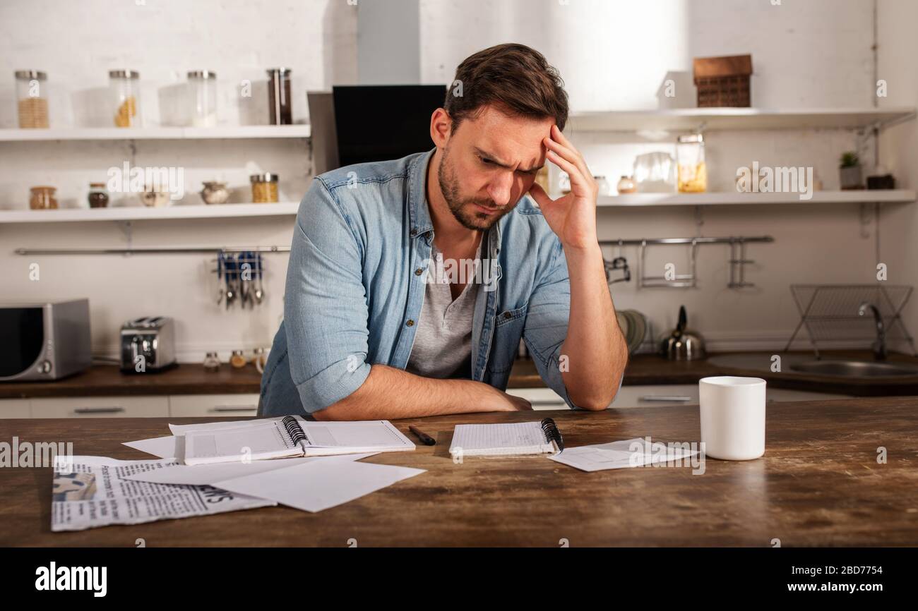 Boy has problems with bills. Concept of economic trouble and failure Stock Photo