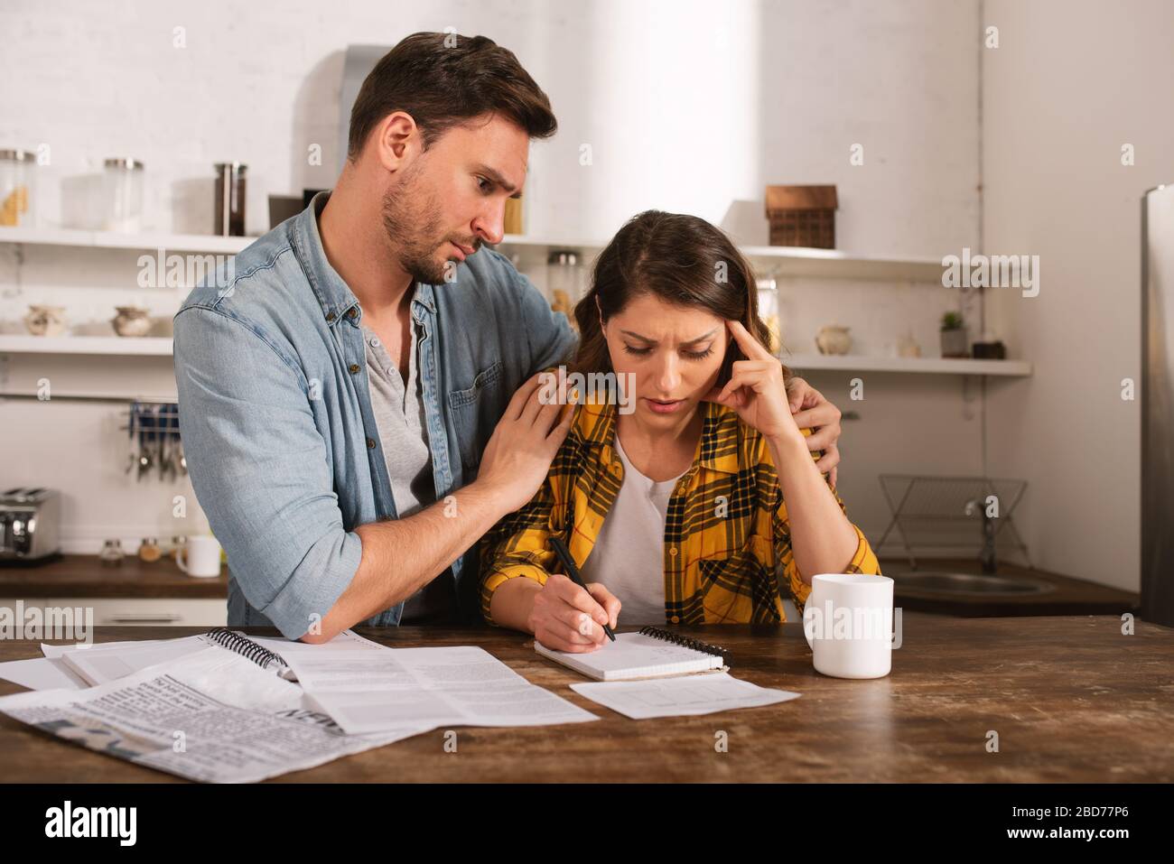 Couple have a problem with bills. Concept of economic trouble and failure Stock Photo