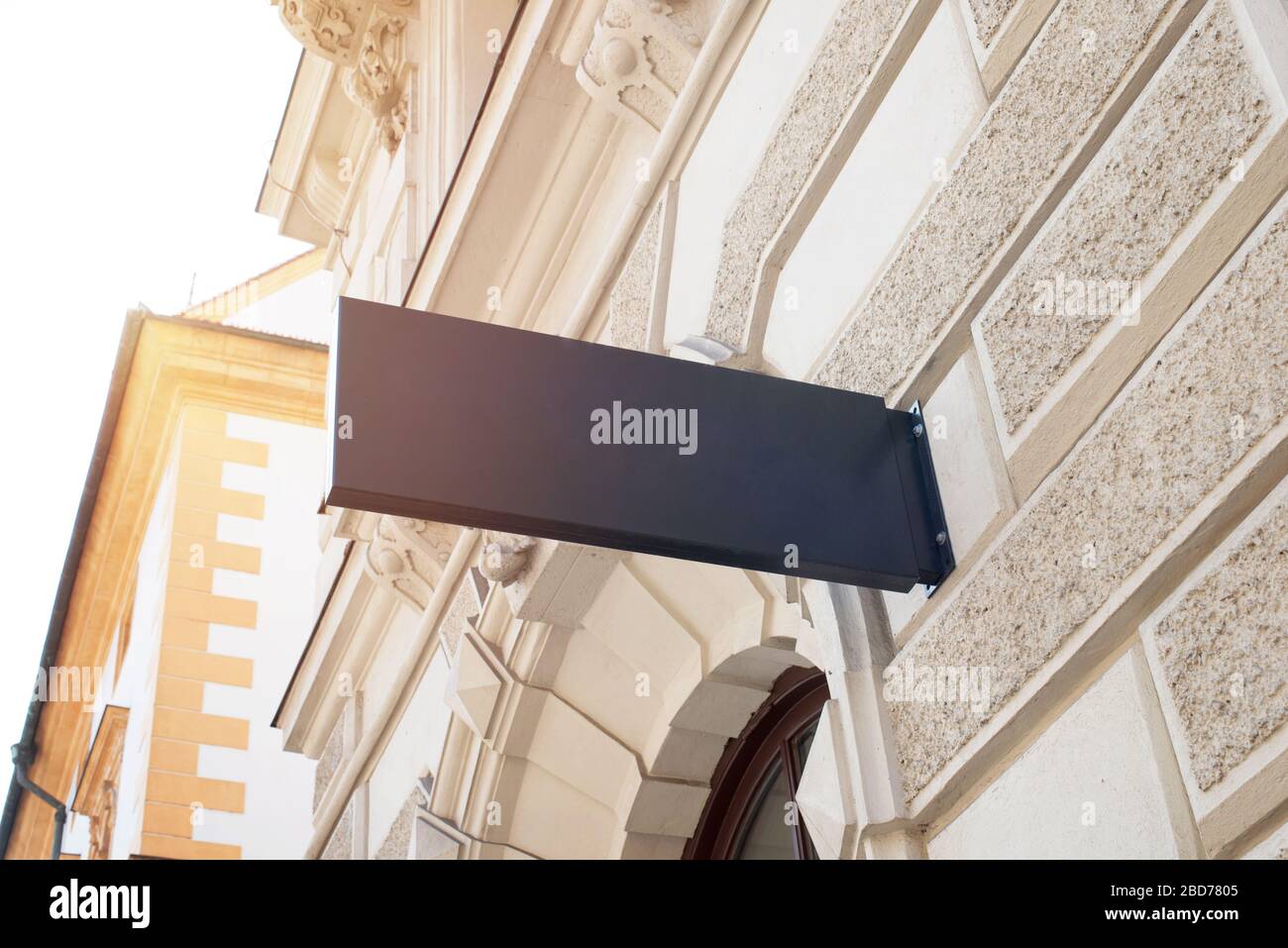 Empty, clean small rectangular sign for company logo mockup on modern city center building wall Stock Photo