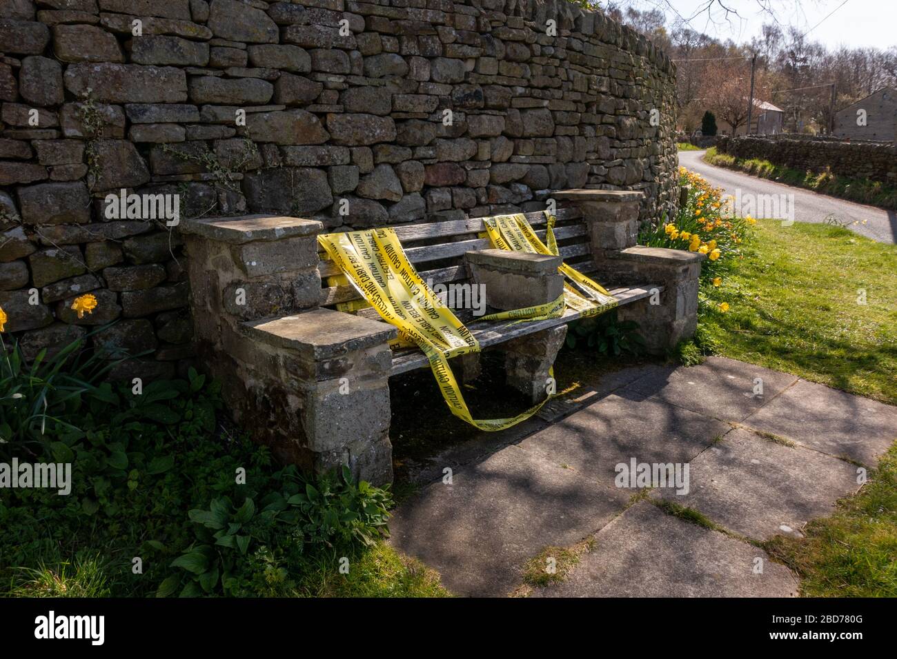 Taped up bench (probably done by locals) preventing people from socialising on it during the Coronavirus crisis and social distancing. Beamsley, North Yorkshire, England, UK Stock Photo