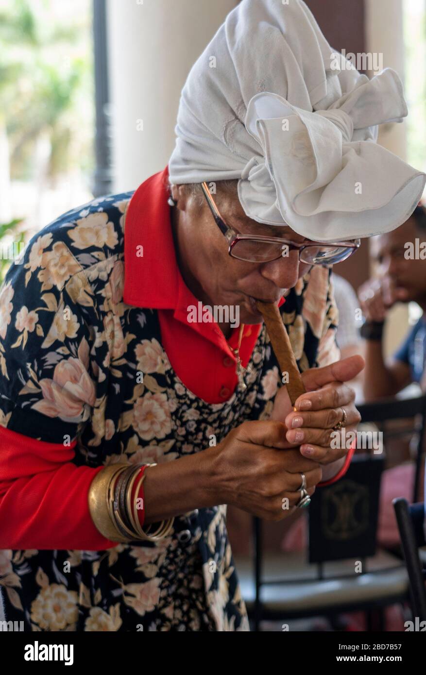 Woman lighting a cuban cicar Stock Photo