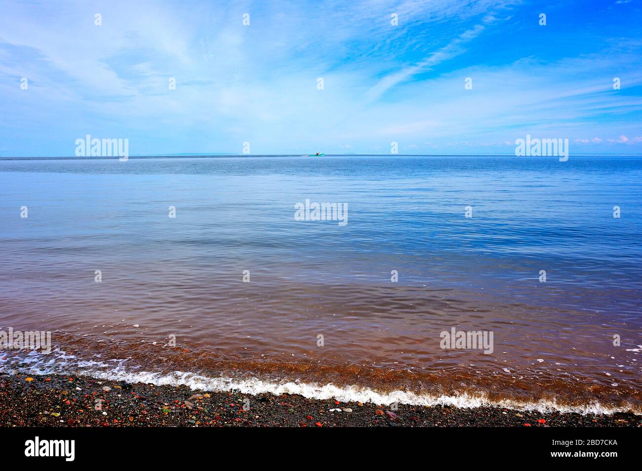 A summer landscape image of the waters of the Bay of Fundy from the beach in Saint Martins New Brunswick Canada. Stock Photo