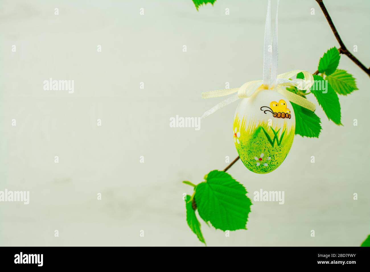 Green tree branch with Easter eggs Stock Photo