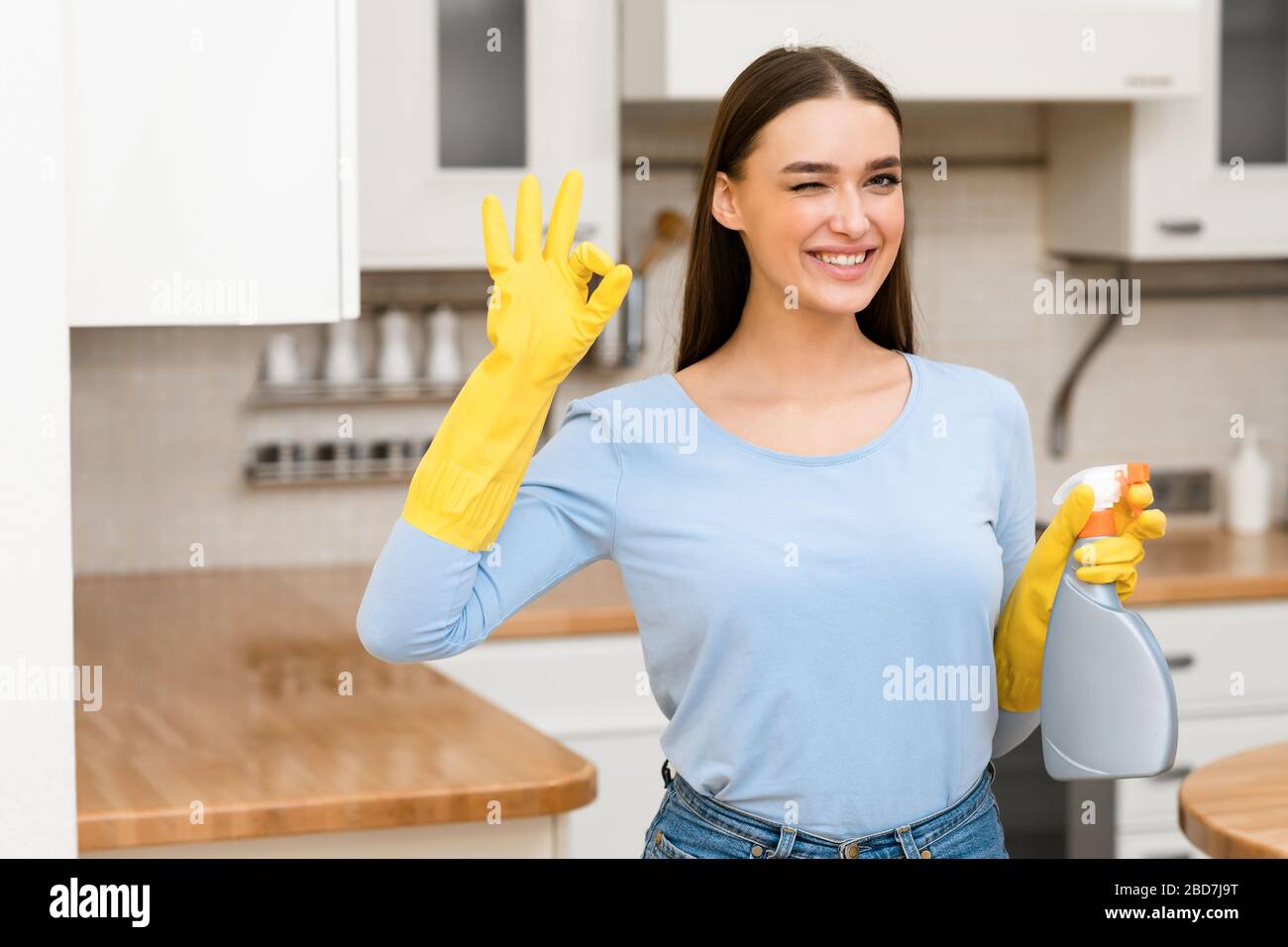 Young woman wearing yellow rubber gloves showing ok sign Stock Photo ...