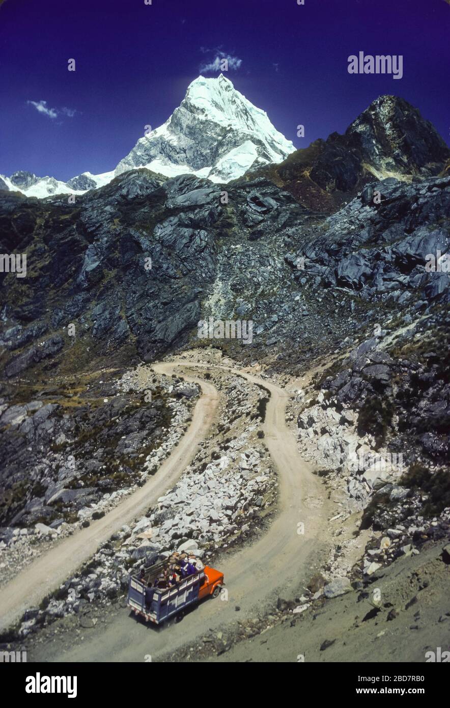 CORDILLERA BLANCA, ANCASH, PERU - Truck on switchback road and Chopicalqui Mountain, 20,847 feet, in Andes mountains. Stock Photo
