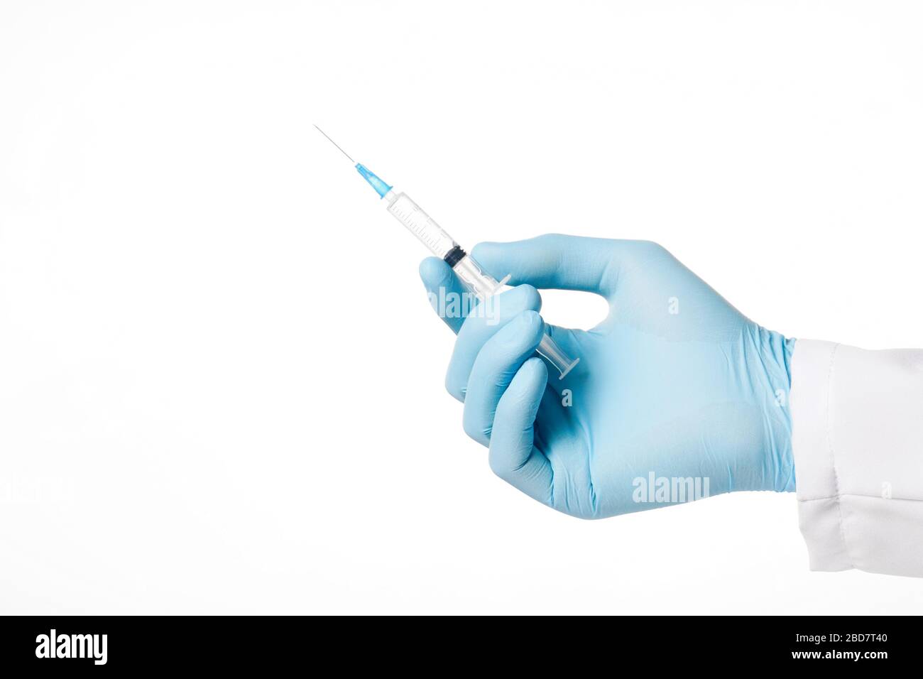 Closeup hand in rubber blue glove holding transparent syringe without cap. Isolated on white background. Vaccination concept Stock Photo