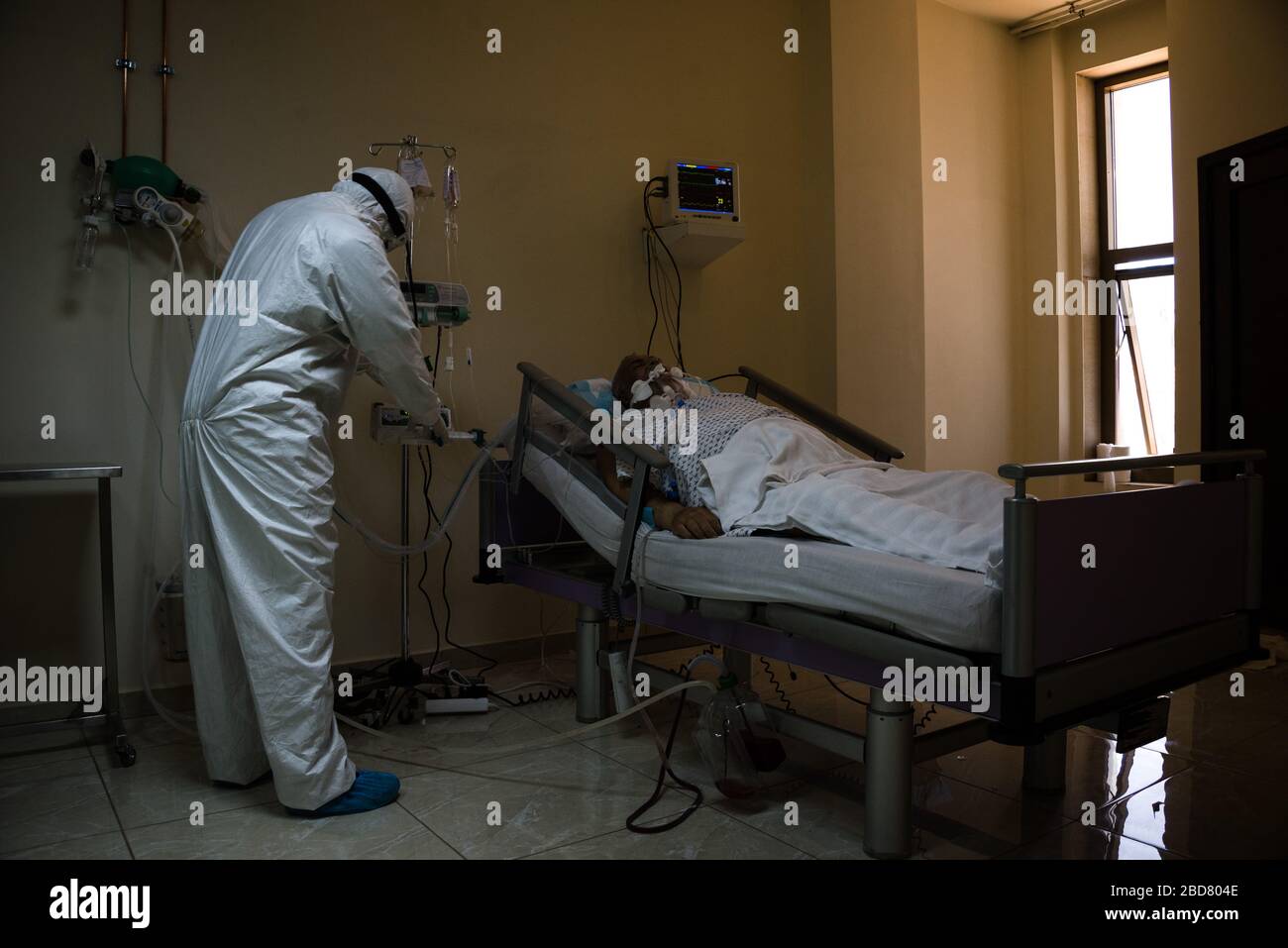 Douris, Lebanon, 7 April 2020. A medic tends to a COVID19 patient on Dar Al Amal University Hospital's COVID Ward A. One of two ICU and five total patients infected with the virus, this man is intubated and using a ventilator.  Elizabeth Fitt Credit: Elizabeth Fitt/Alamy Live News Stock Photo