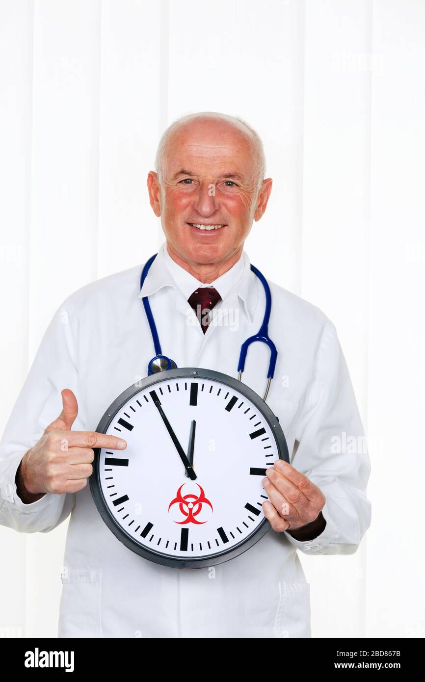 doctor holding a clock with sign biological for hazard, high time Stock Photo
