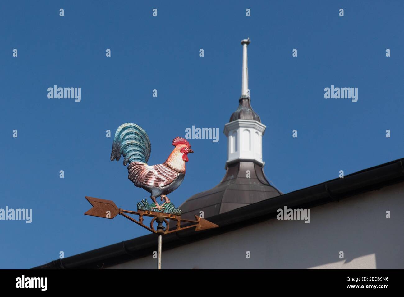 A hen chicken wind spinner from Willesden Salvage with the dome of the New Testament Church of God in the background Stock Photo