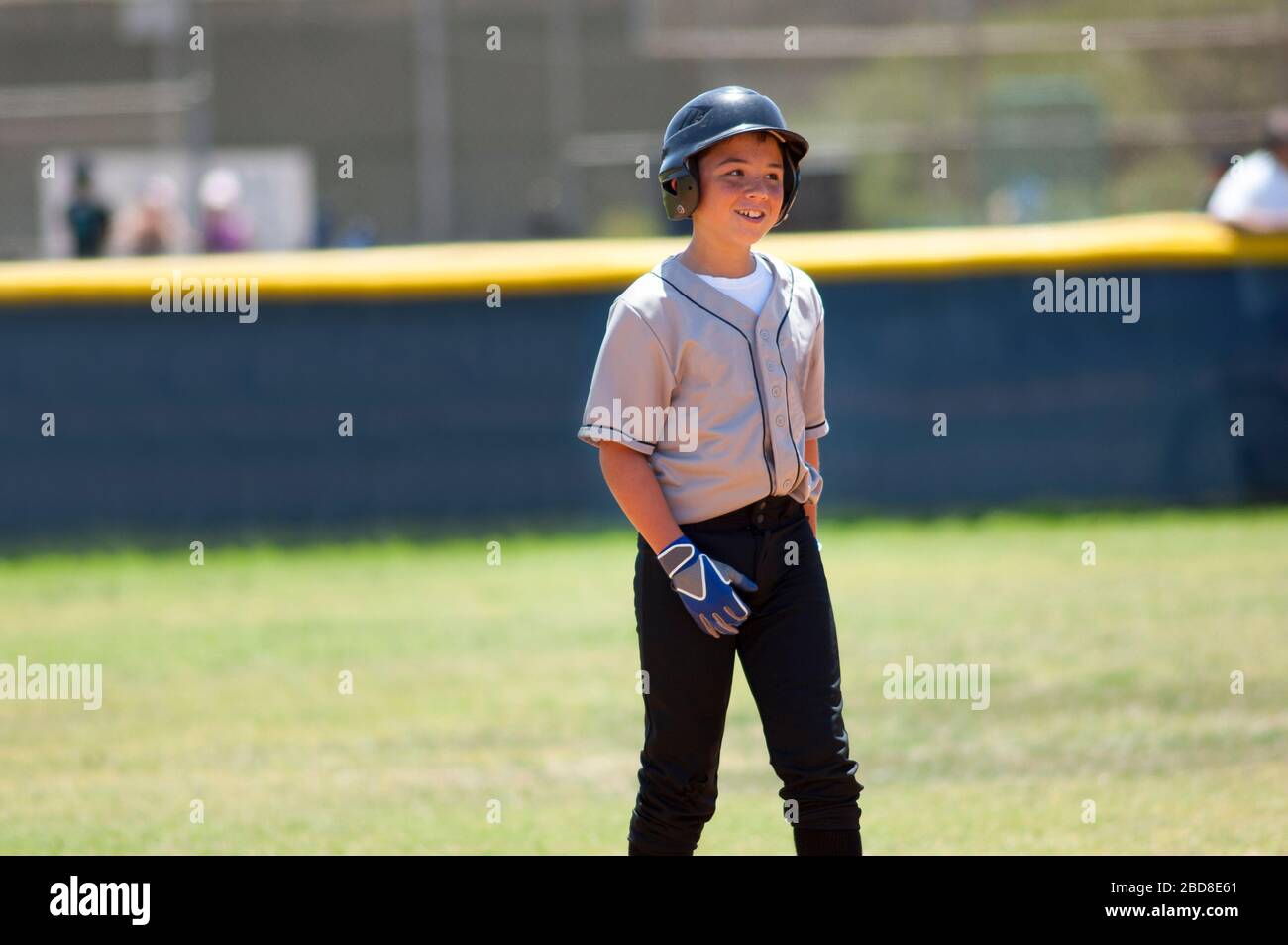 Little league player in baseball helmet smiling Stock Photo Alamy