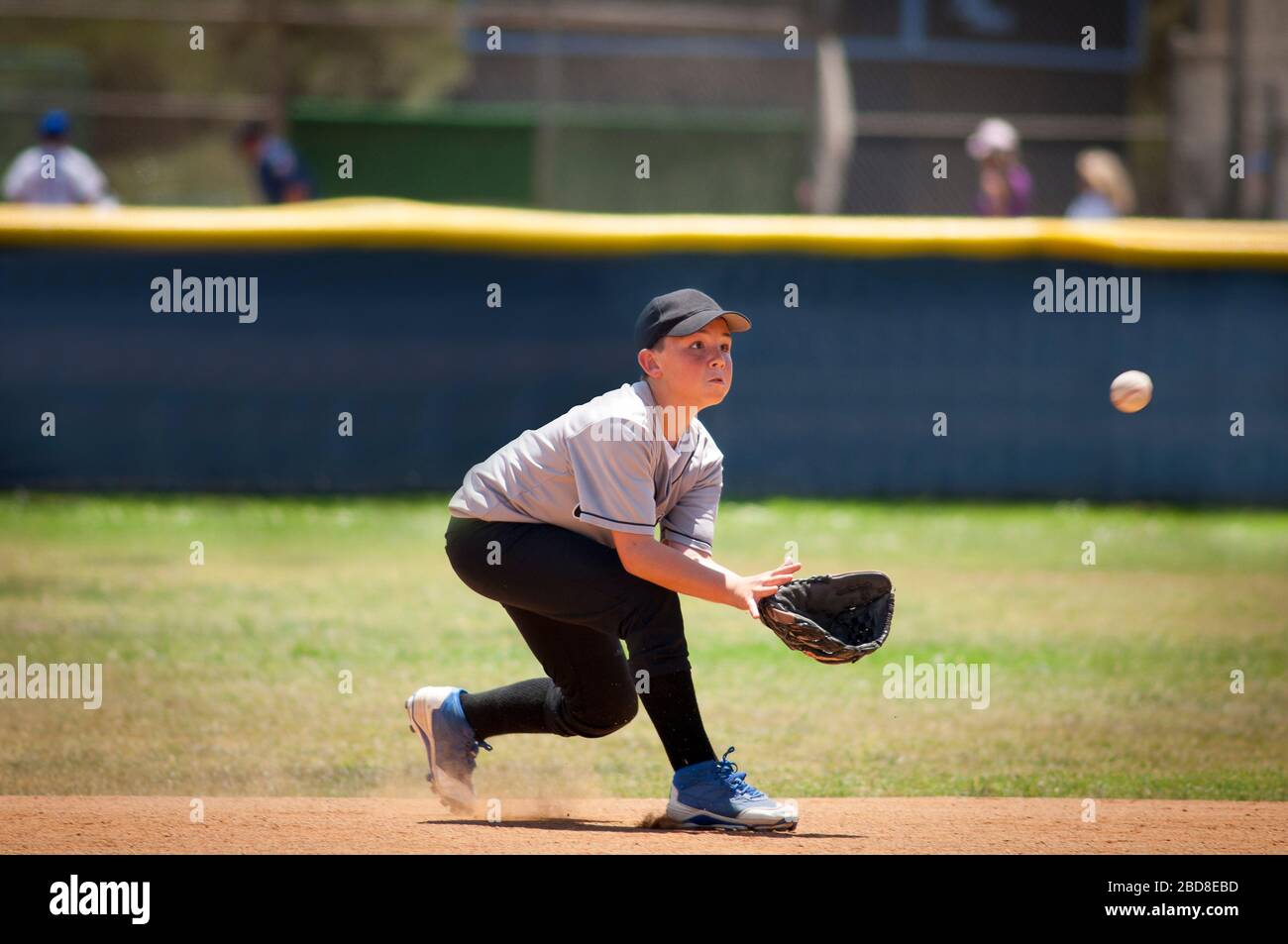 Little League infielder about to catch a baseball Stock Photo