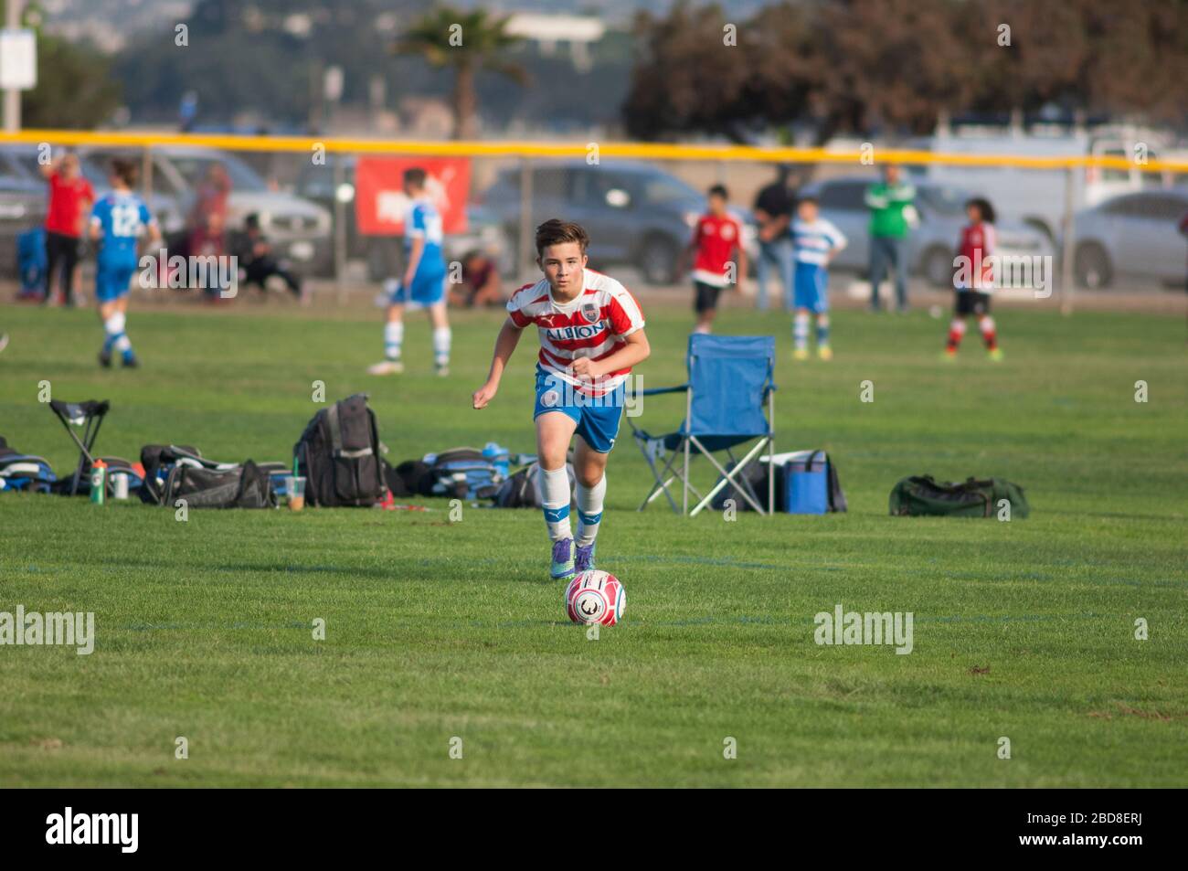 Teen soccer player about to strike the ball on a free kick Stock Photo