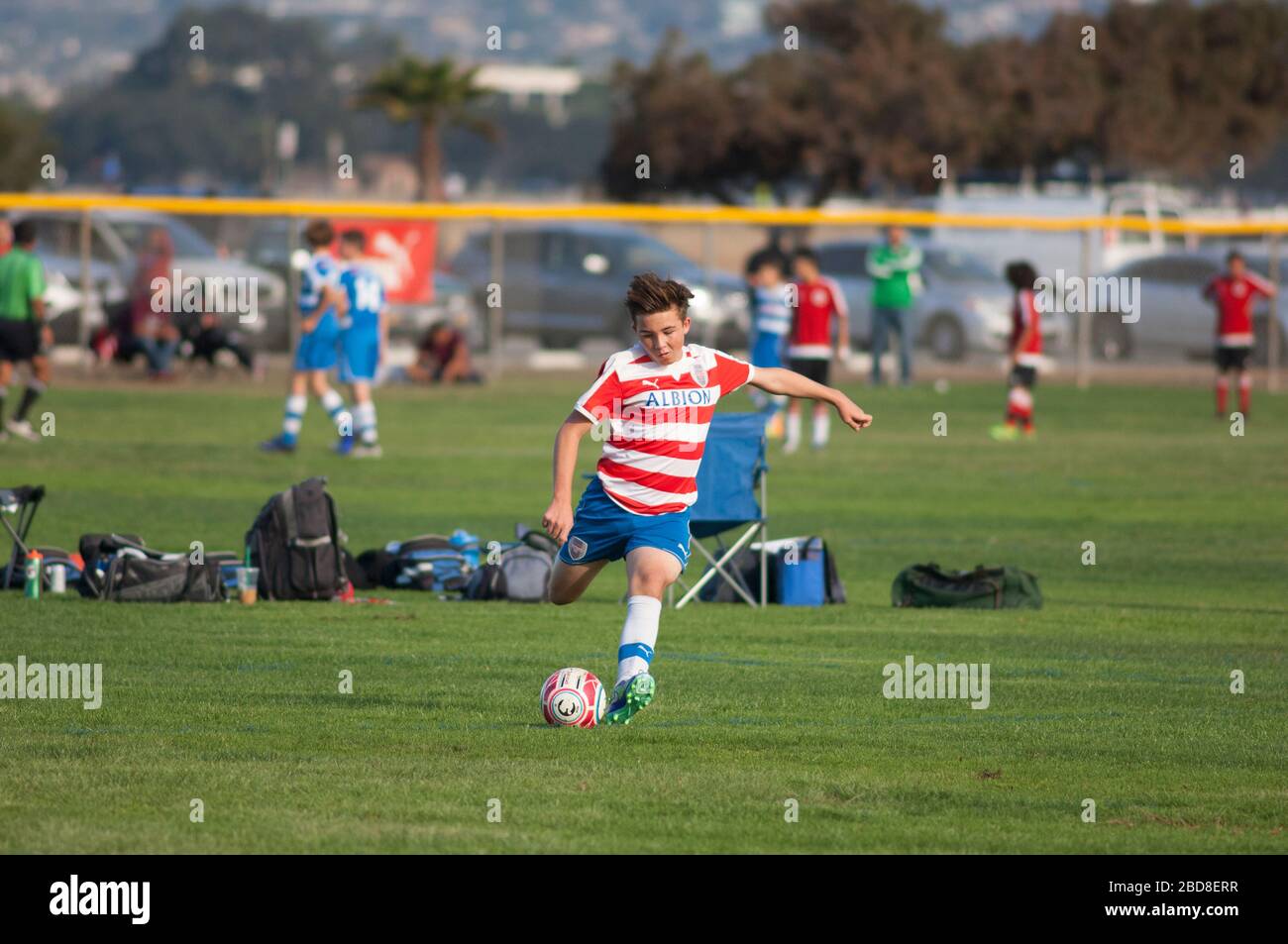 Teen soccer player about to strike the ball on a free kick Stock Photo