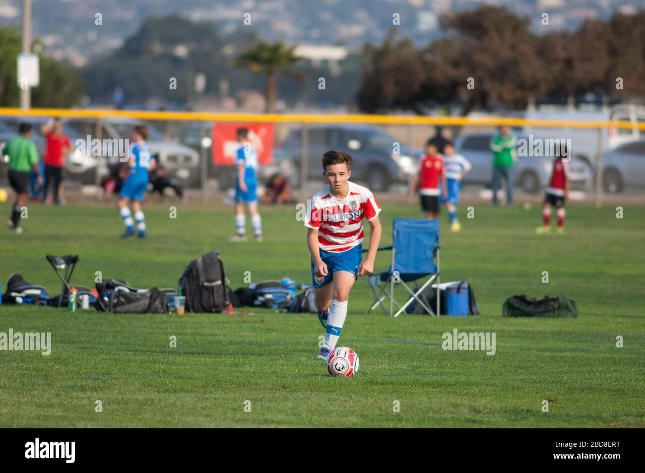 Teen soccer player about to strike the ball on a free kick Stock Photo