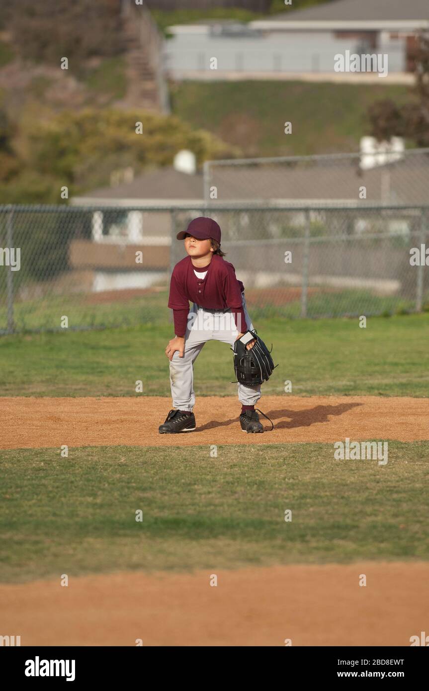Little League baseball boy in ready position in the infield Stock Photo