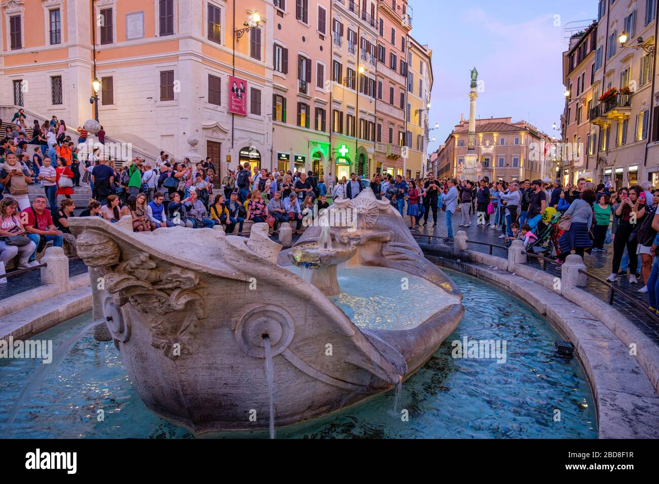 Overtourism, mass tourism, crowds of tourists at Piazza di Spagna, Spanish Steps, Fontana della Barcaccia, Rome, Italy. Stock Photo