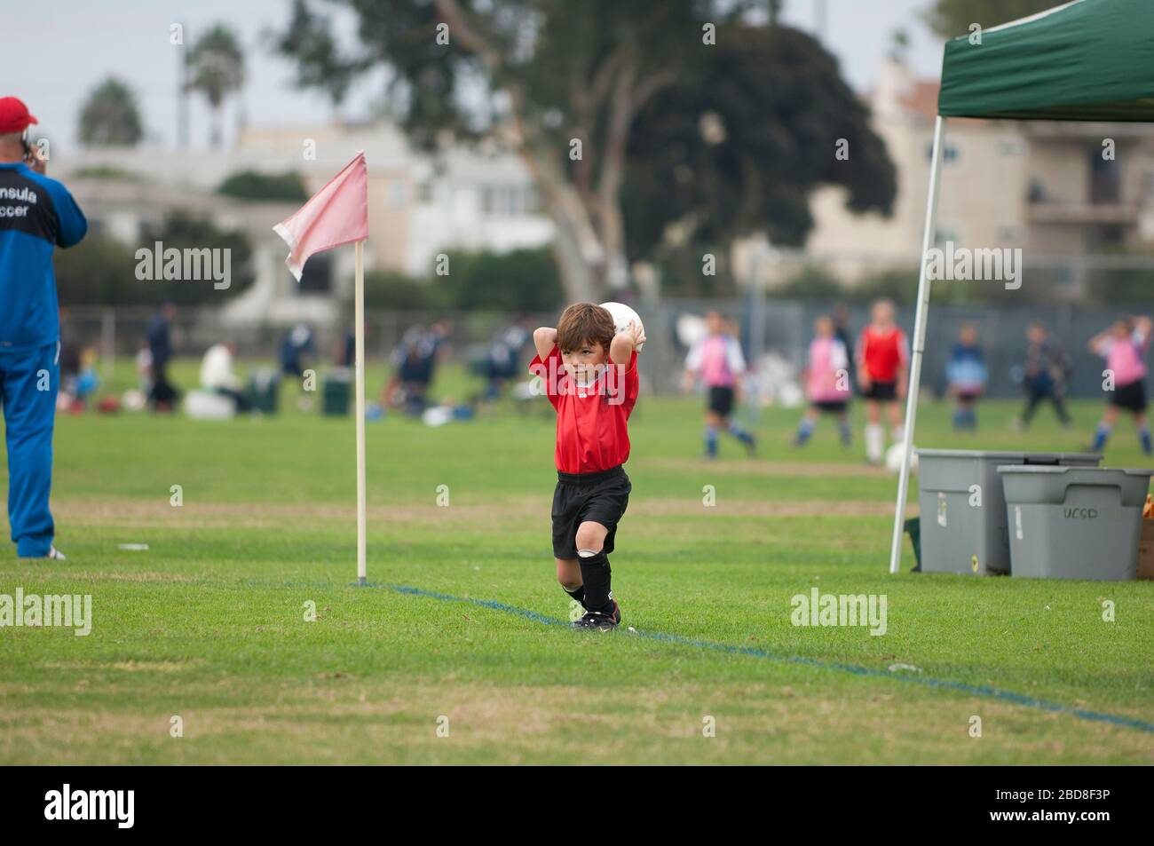 young soccer player attempting a throw in Stock Photo