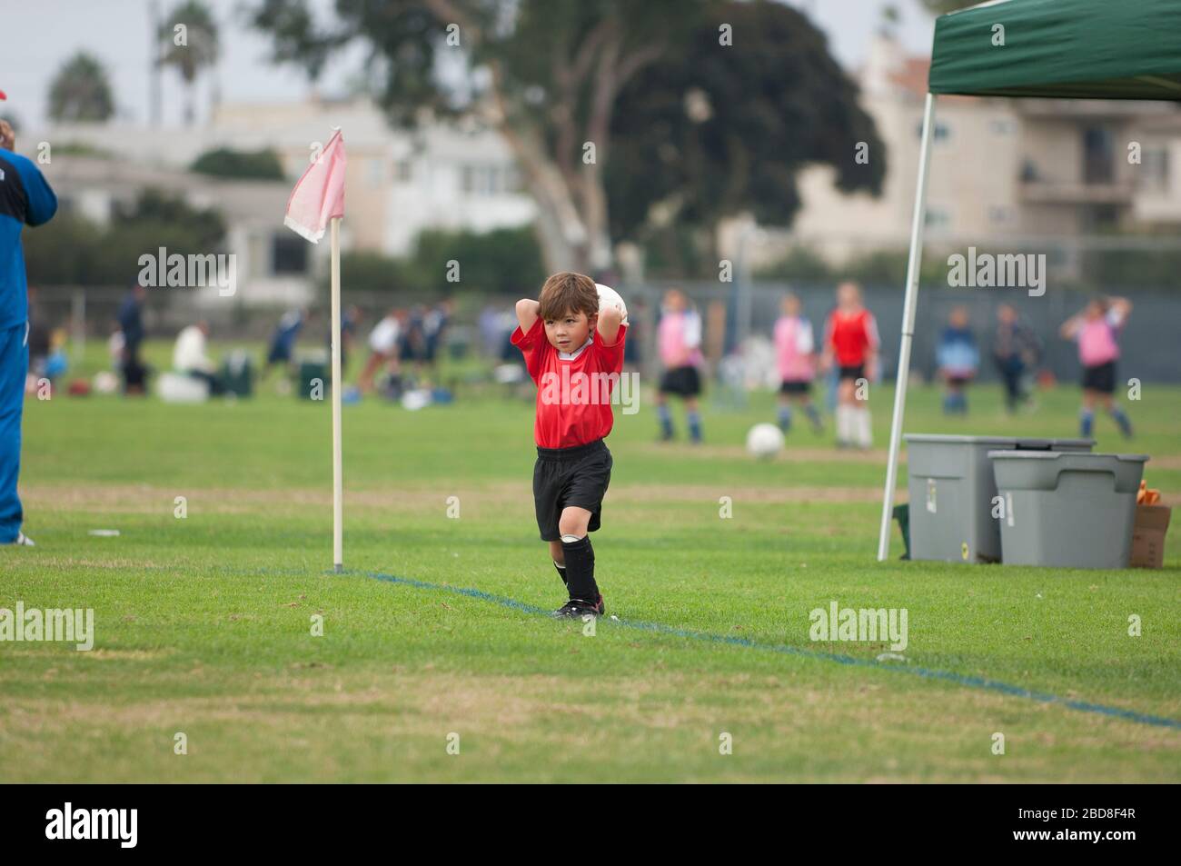 Young boy about to do a throw in on a soccer field Stock Photo