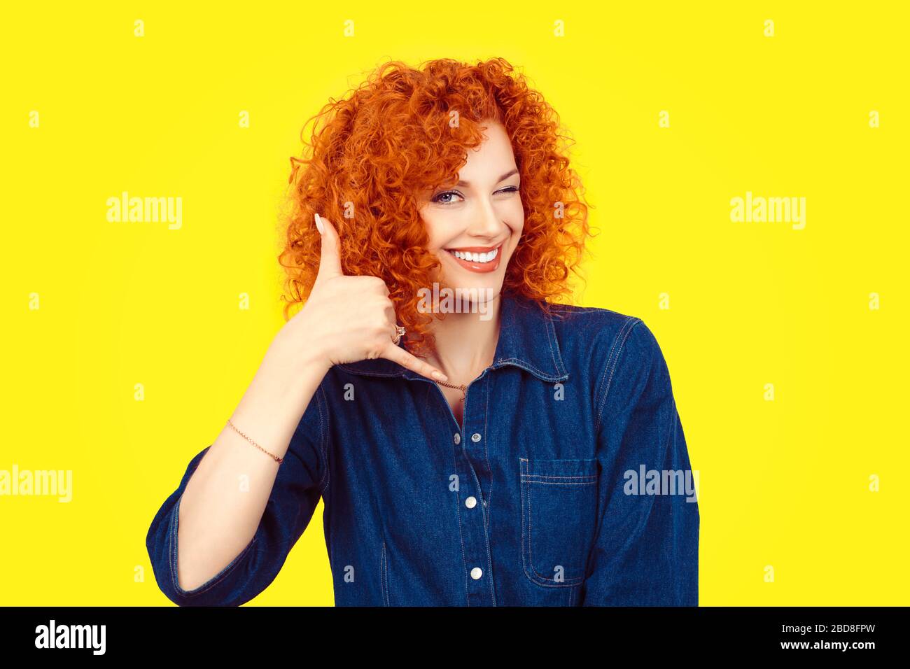 Give me a call. Closeup portrait young red head curly single woman excited  happy student winking with eye making showing call me gesture sign with han  Stock Photo - Alamy