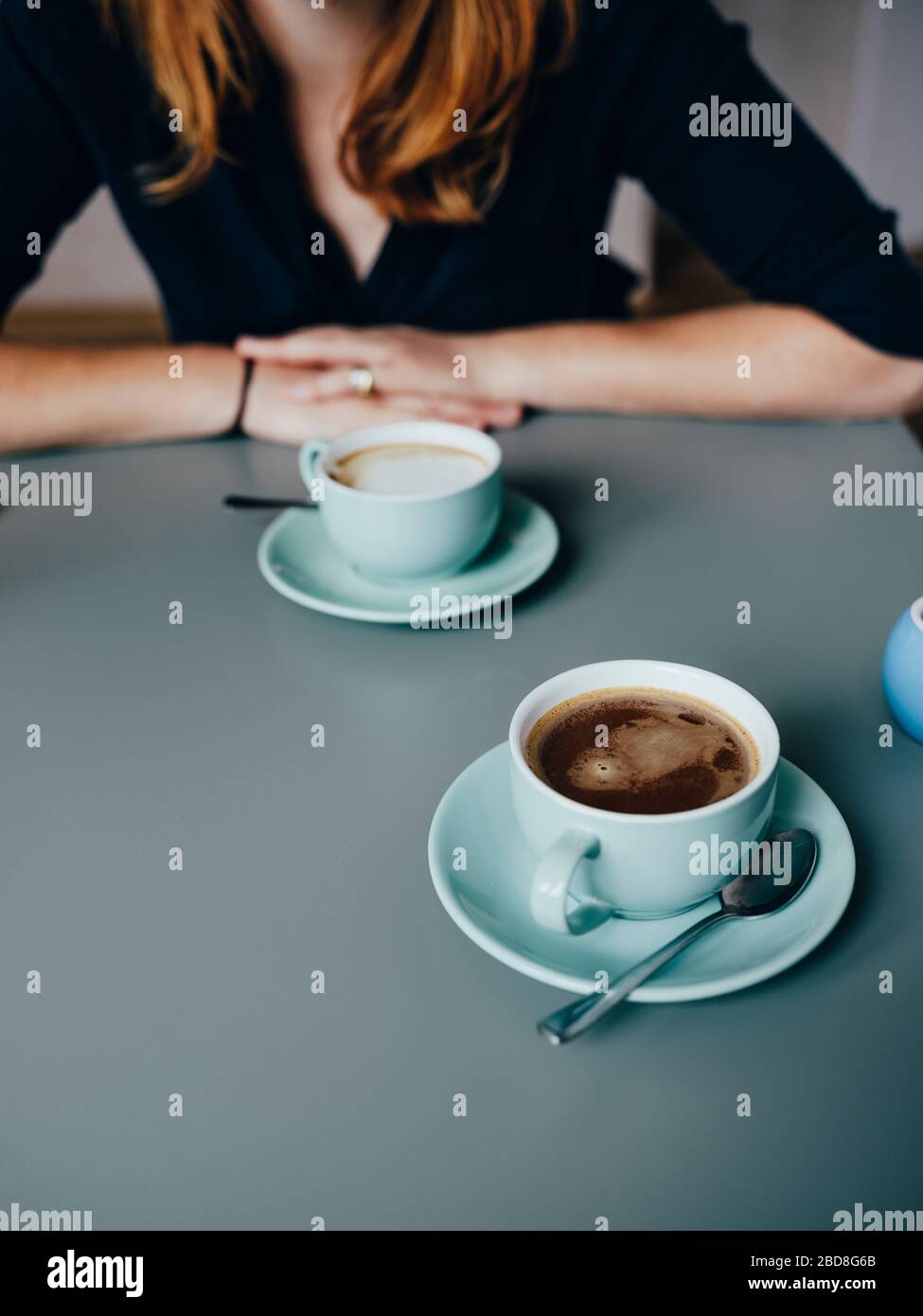 A woman and two cups of coffee in cafe Stock Photo