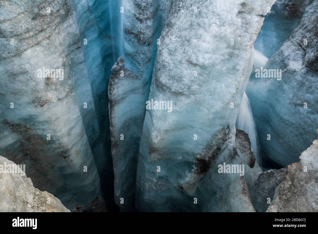 Deep glacial moulin on the surface of Snowbird Glacier, Talkeetna Mountains, Alaska. Stock Photo