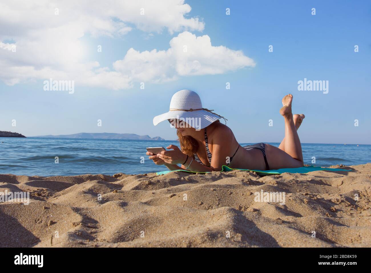 Woman enjoying summer vacation on the beach in Heraklion, Greece Stock Photo