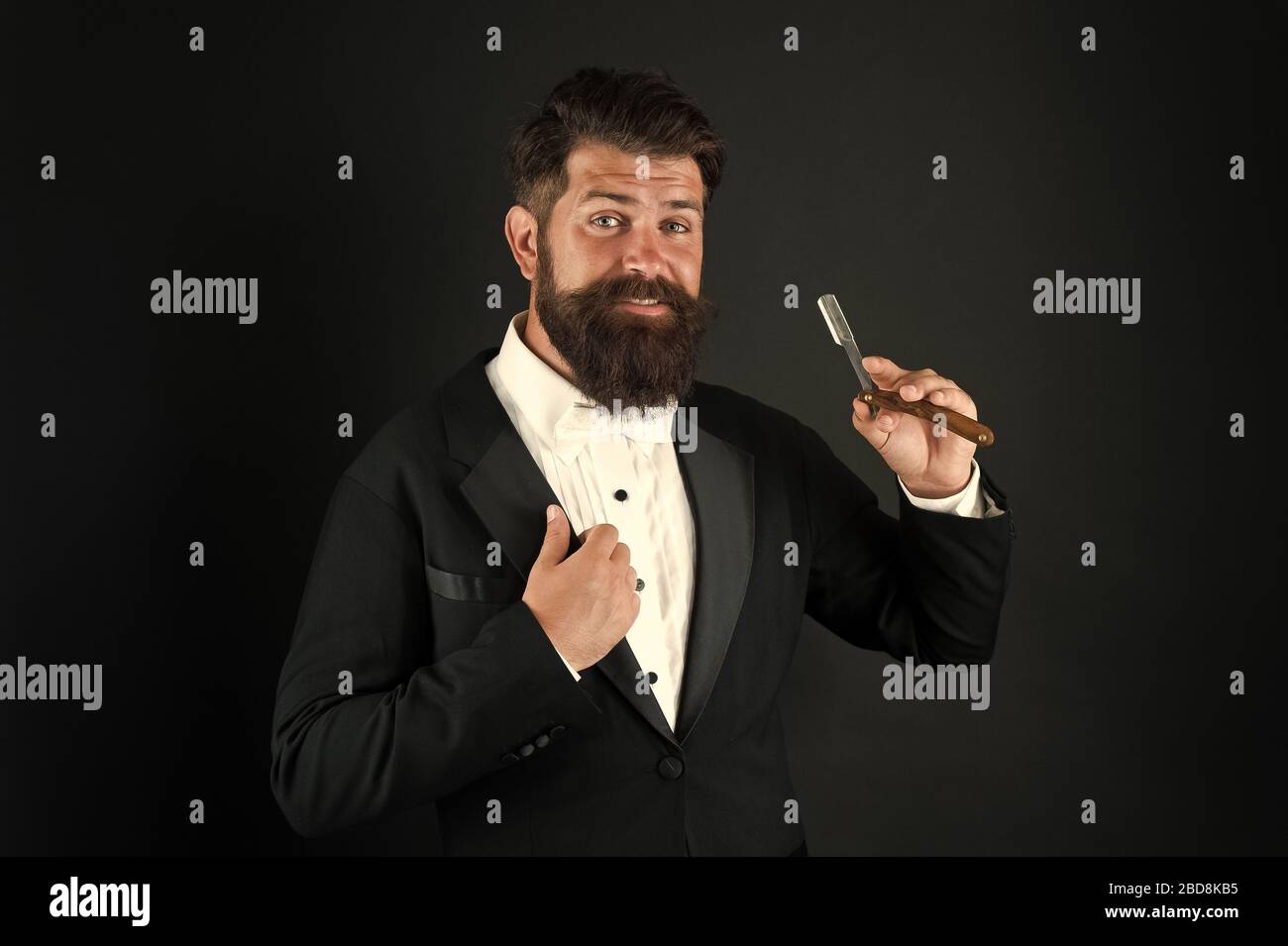 Retro hipster. Hipster hold straight razor. Brutal hipster wear beard ...