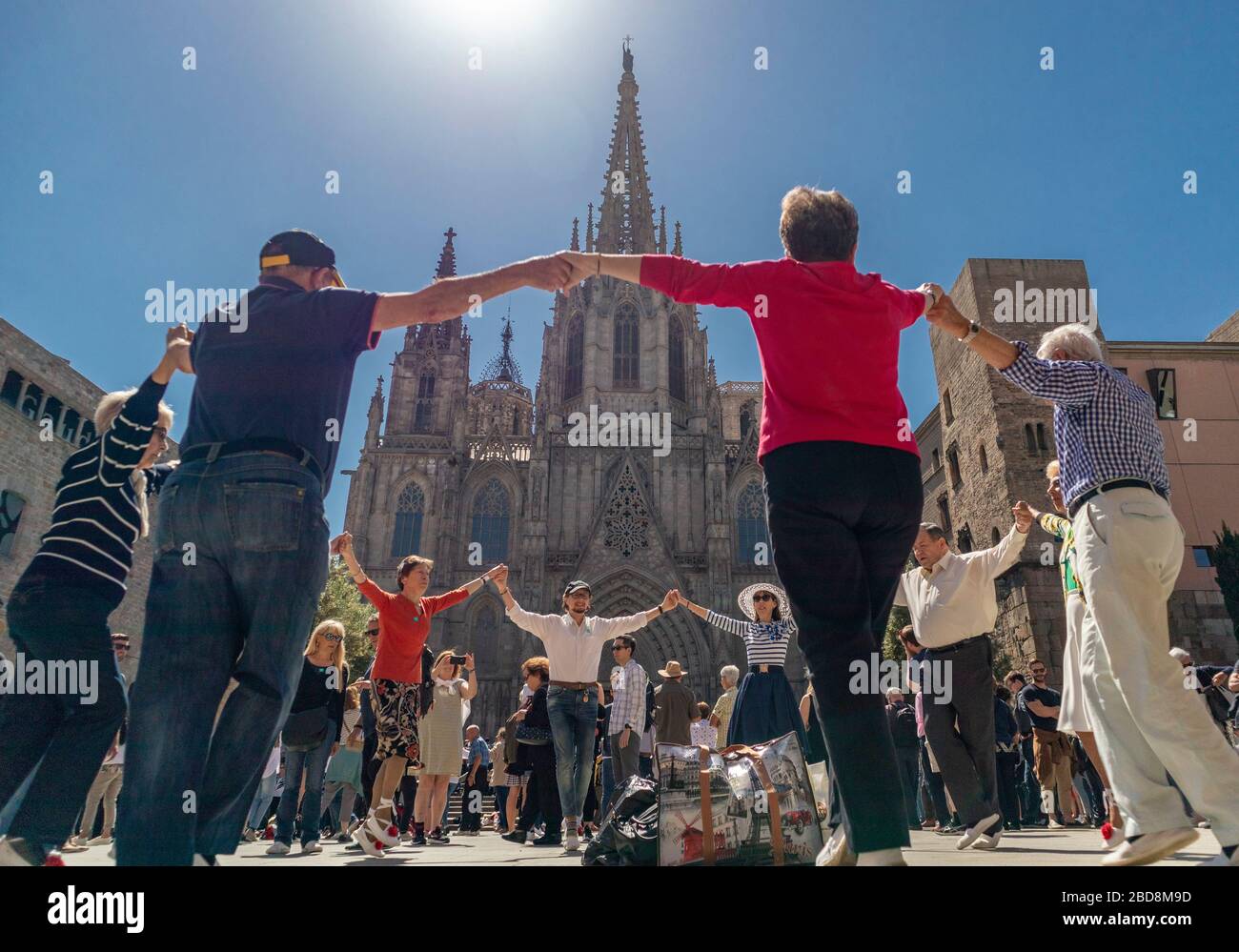 Older people dancing the typical sardana dance of Catalan culture. Stock Photo