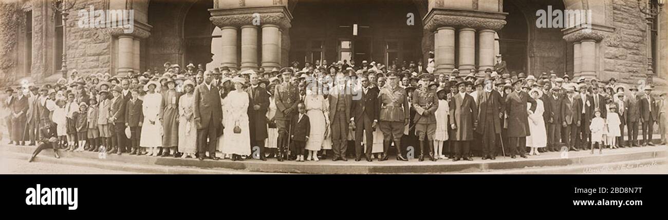 'English: A group of mostly black Canadians poses with Premier Ernest C. Drury and Sir Henry Pellatt on the steps of the Ontario Legislature in Toronto.  The photograph was taken at the dedication of a plaque in memory of the members of the No. 2 Construction Battalion, an all-Black non-combat battalion that served in World War I. The plaque was (and is) in the main hall of Queen's Park.  Rev. Mrs. H.F. Logan and Rev. H.F. Logan, who spearheaded the campaign for the plaque, are at left of centre. Also included in the photograph is Rt. Rev. Samuel R. Drake, General Superintendent of the British Stock Photo
