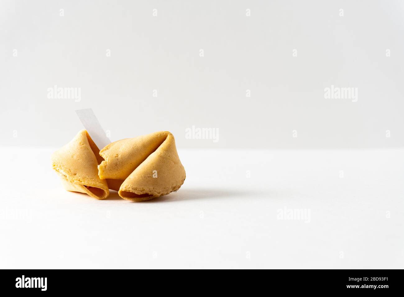 Two fortune cookies on a bright white background with a blank space for a fortune and copy space; landscape view Stock Photo