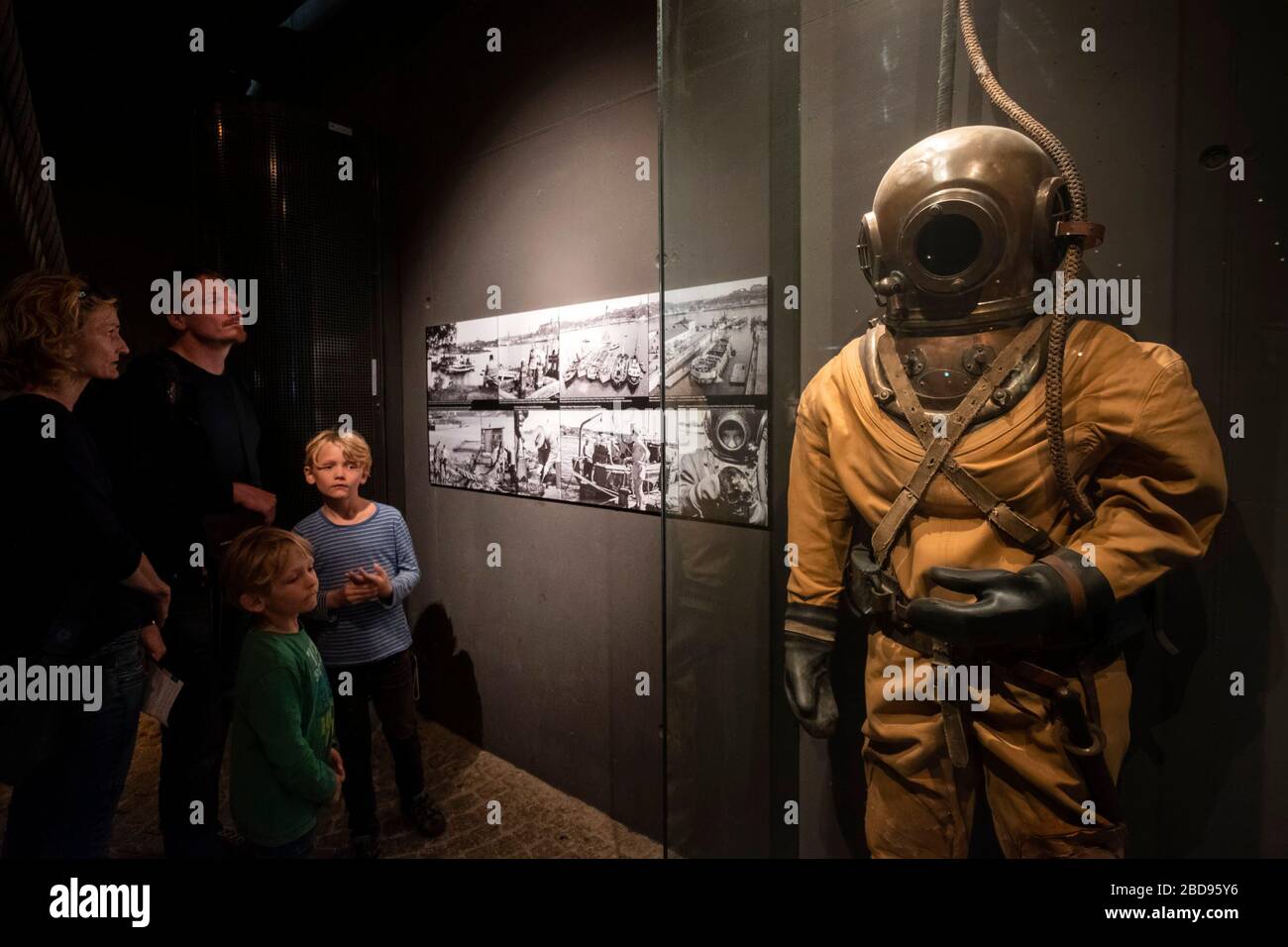 Family looking at an old diving suit at the Vasa Museum in Stockholm, Sweden, Europe Stock Photo
