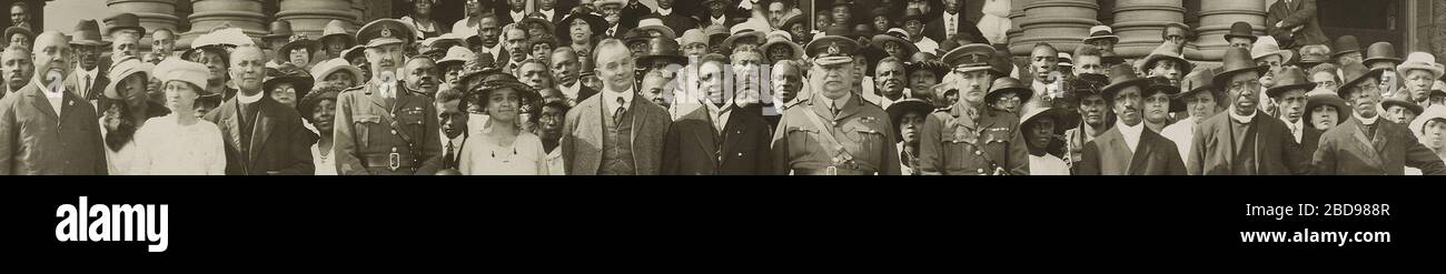 'English: Close-up of a group of mostly black Canadians poses with Premier Ernest C. Drury and Sir Henry Pellatt on the steps of the Ontario Legislature in Toronto.  The photograph was taken at the dedication of a plaque in memory of the members of the No. 2 Construction Battalion, an all-Black non-combat battalion that served in World War I. The plaque was (and is) in the main hall of Queen's Park.  Rev. Mrs. H.F. Logan and Rev. H.F. Logan, who spearheaded the campaign for the plaque, are at left of centre. Also included in the photograph is Rt. Rev. Samuel R. Drake, General Superintendent of Stock Photo