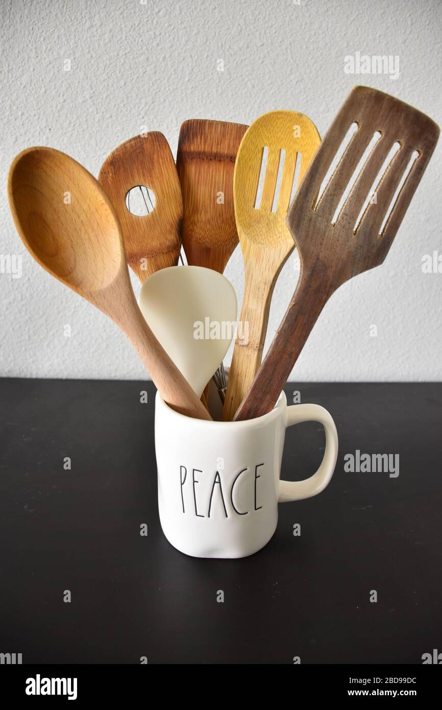 Kitchen spatulas in a cup isolated white background wooden Stock Photo