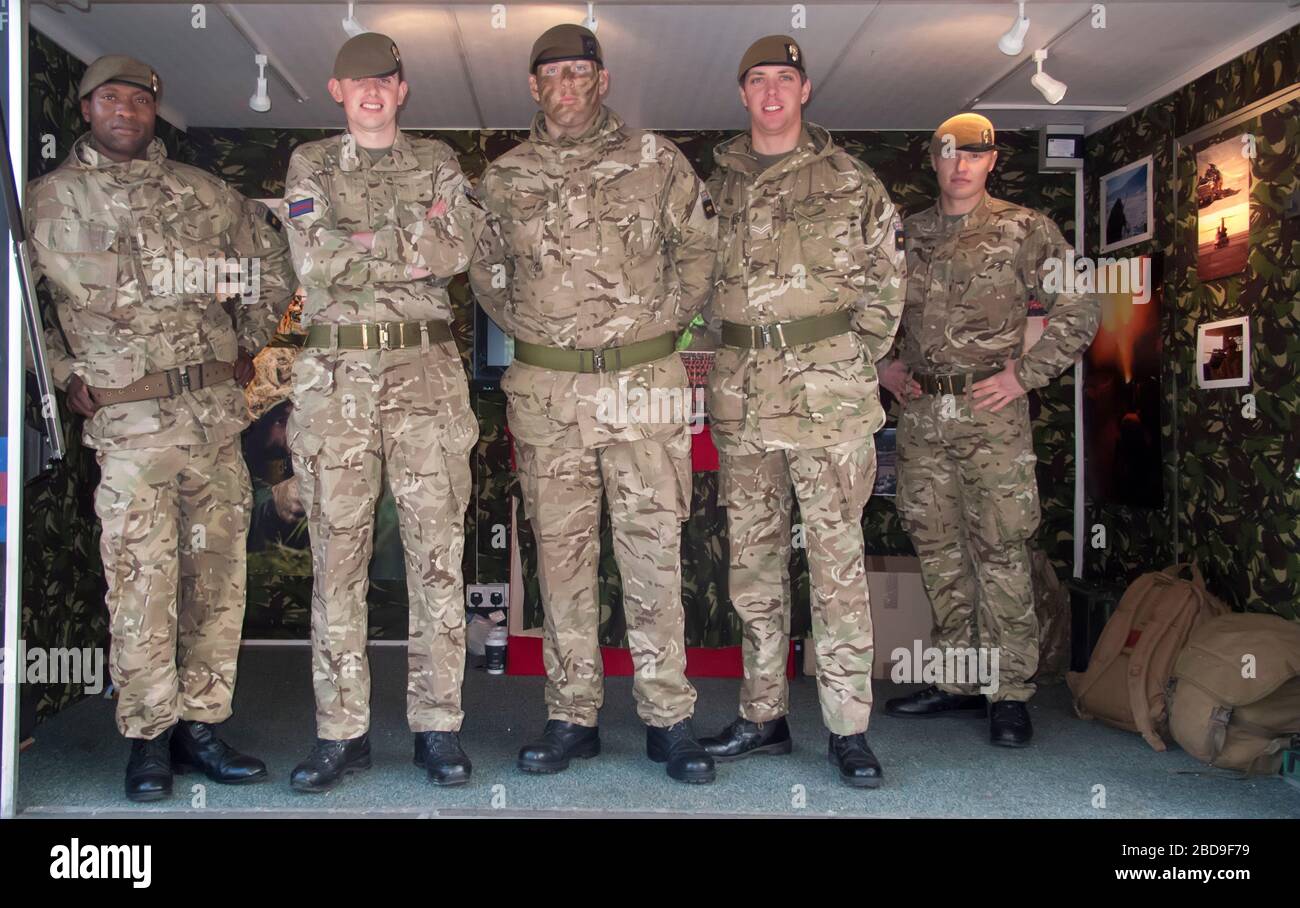 British soldiers pose for photo in army recruitment module, Birmingham, UK Stock Photo