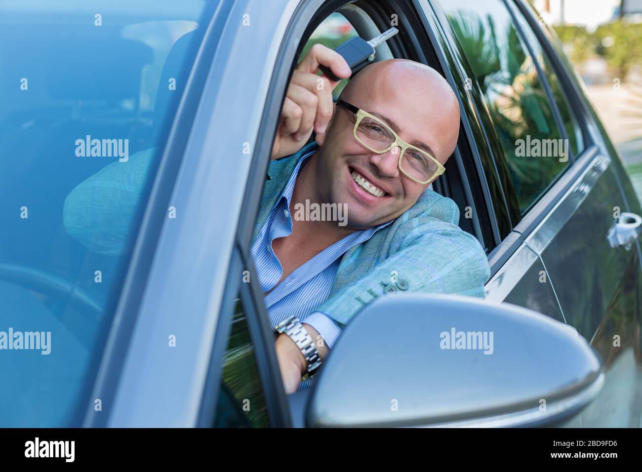 Handsome business man showing keys of his new car Stock Photo - Alamy