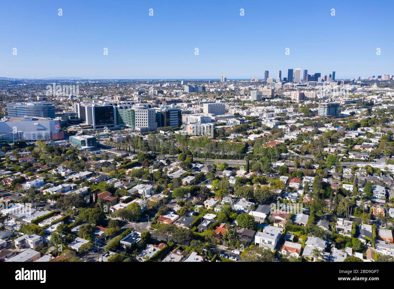 Aerial views over Mid-Wilshire in central Los Angeles under a blue sky Stock Photo