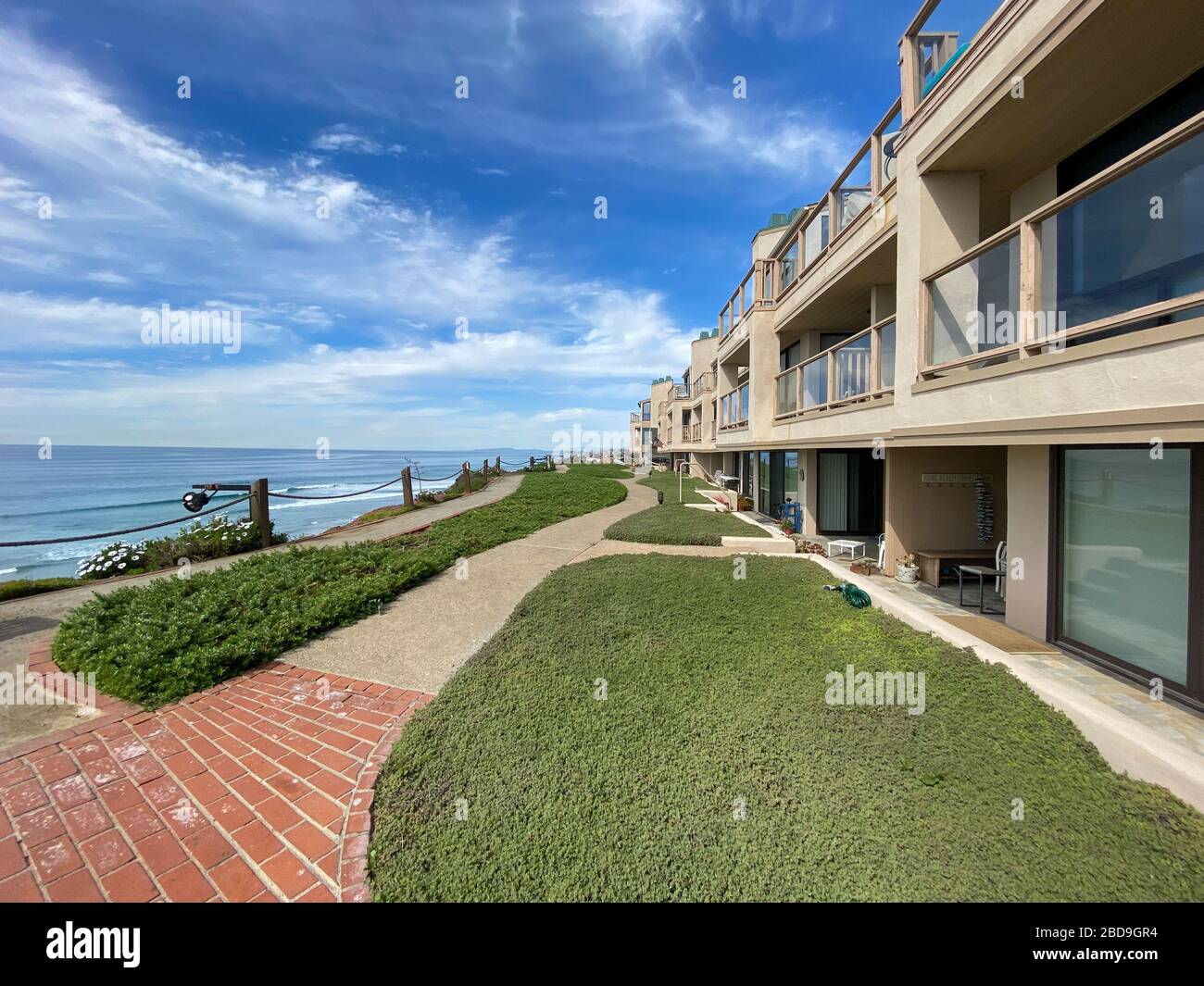Clean garden and lawn along the walk path through the typical apartment
